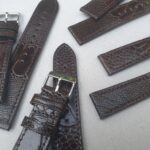 Ostrich Brown leather watch straps flat on table