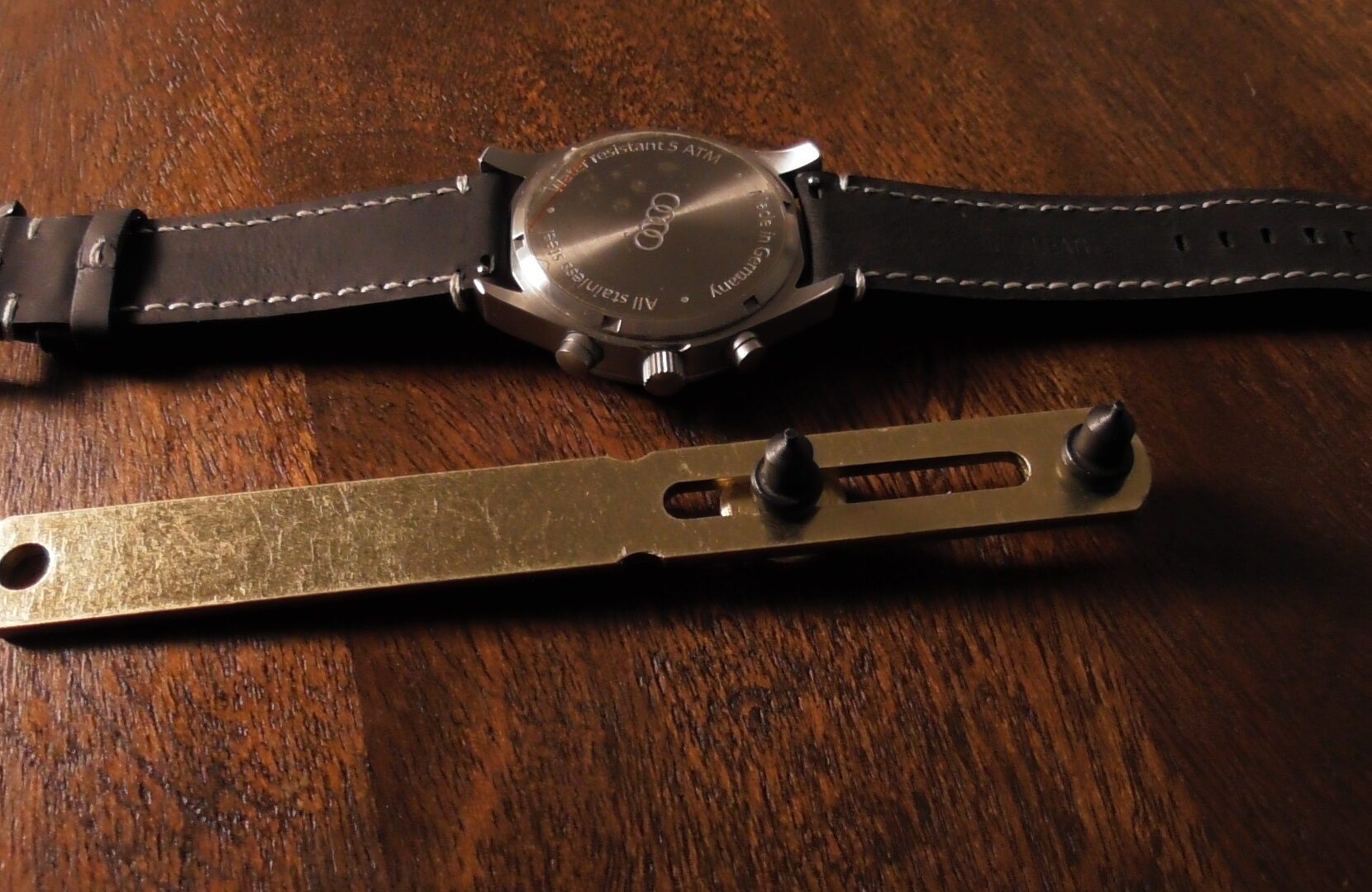 steel watch case opener with audi watch