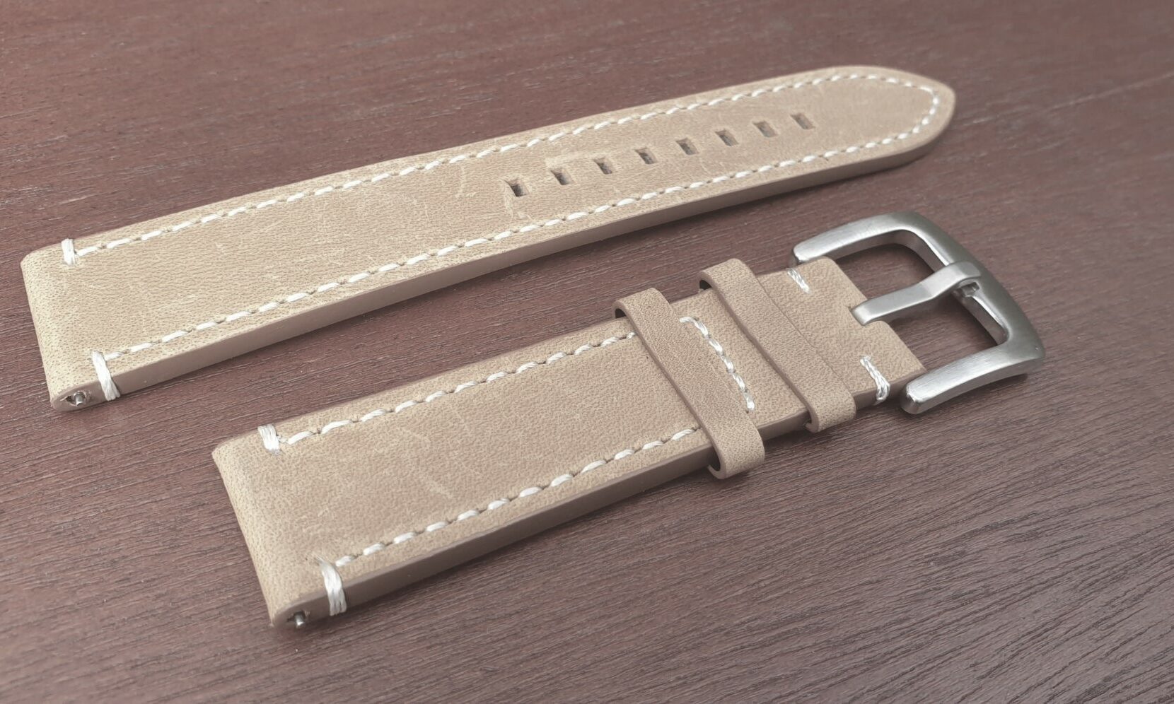 tan leather watch strap with silver buckle white stitching