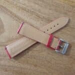 underside of red leather watch strap showing quick release pins