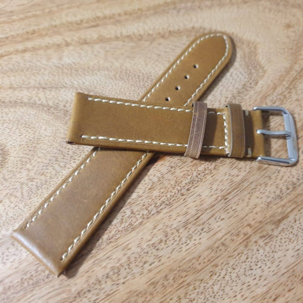 Dark tan leather watch band with white edge stitching