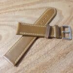 Dark tan leather watch band with white edge stitching