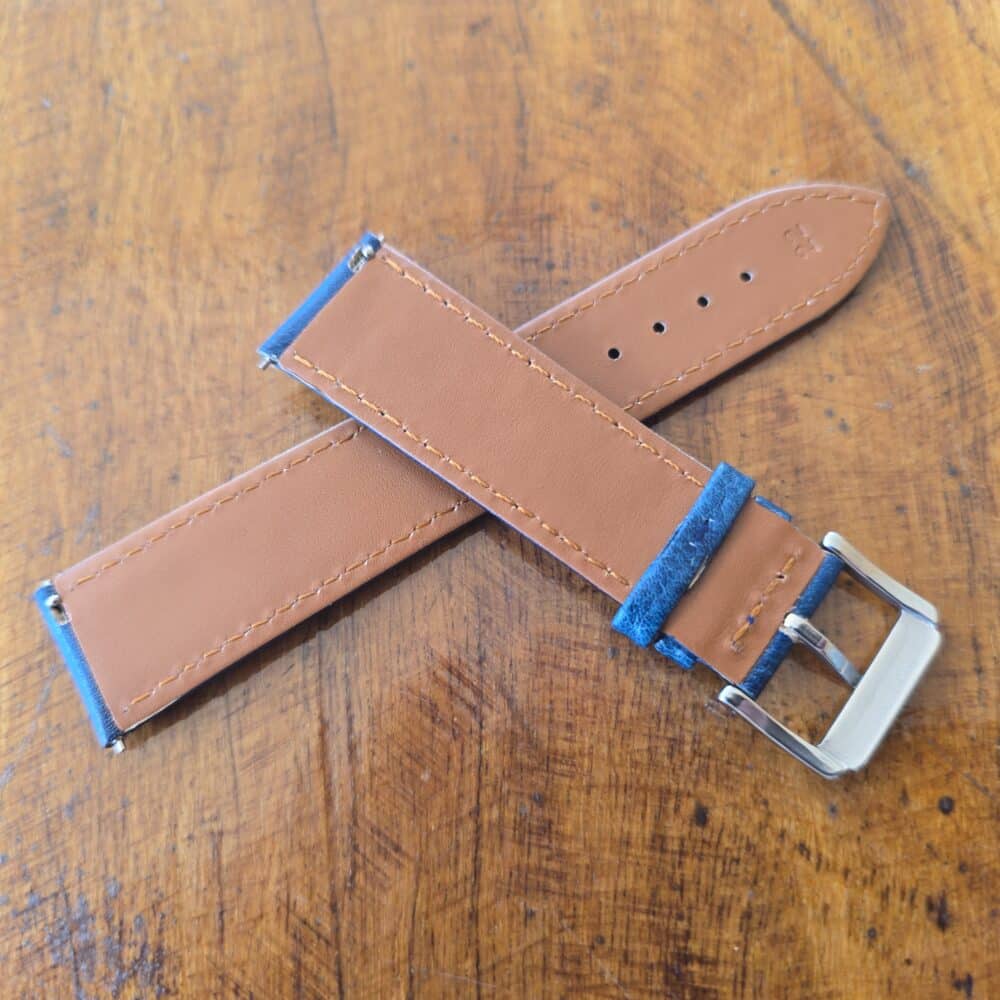 underside of a blue cowhide leather watch strap showing quick release spring bars