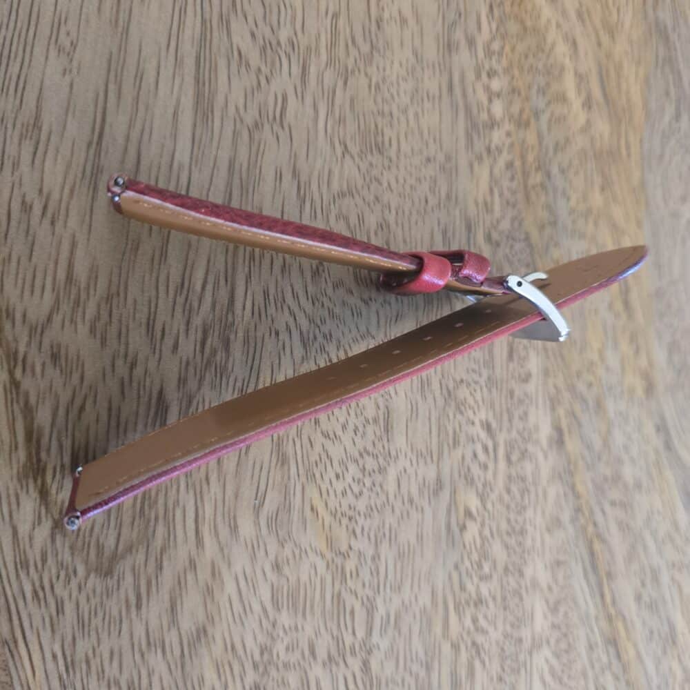 sideview of red leather watch strap showing thickness and padding