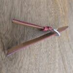 sideview of red leather watch strap showing thickness and padding