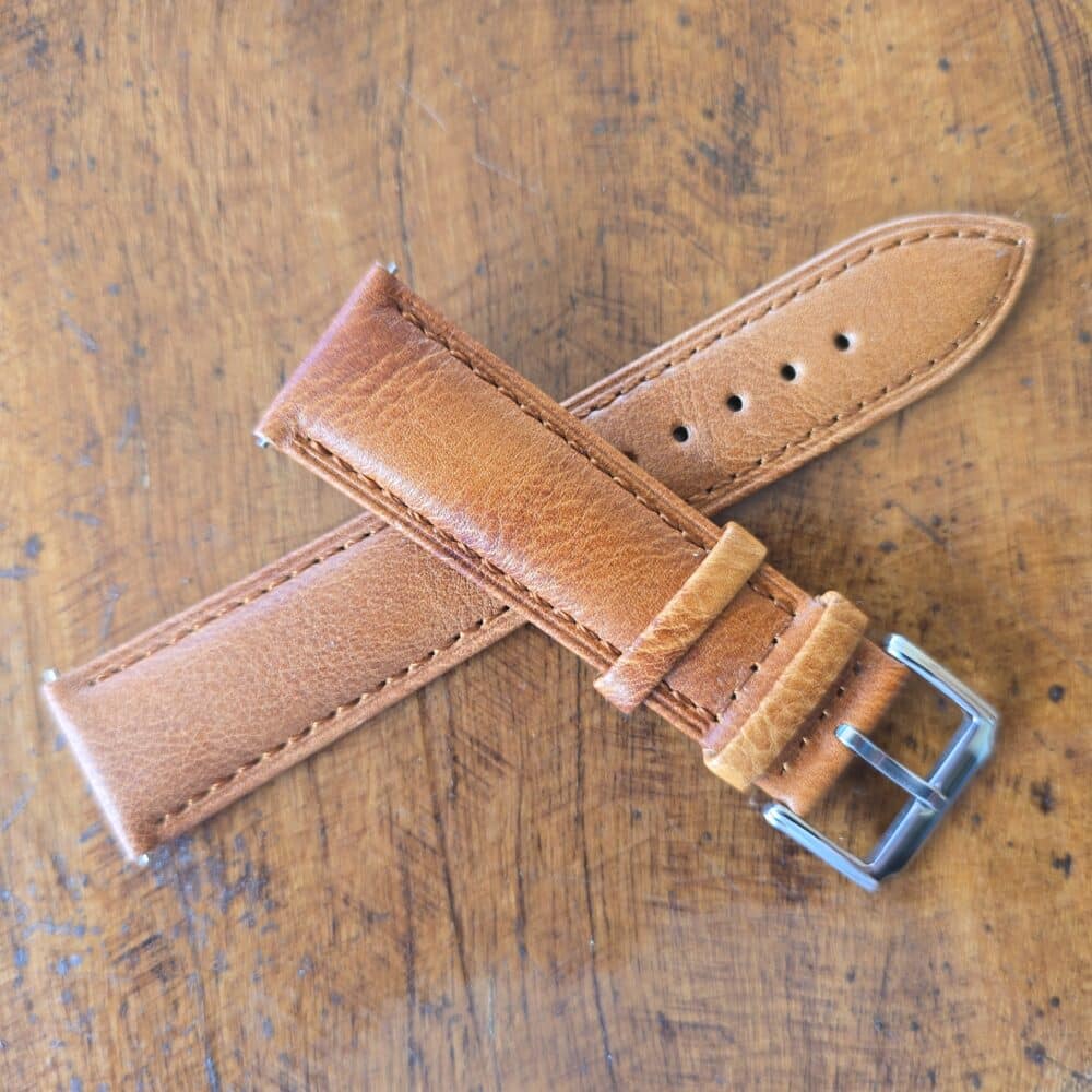 tan leather watch band crossed each piece